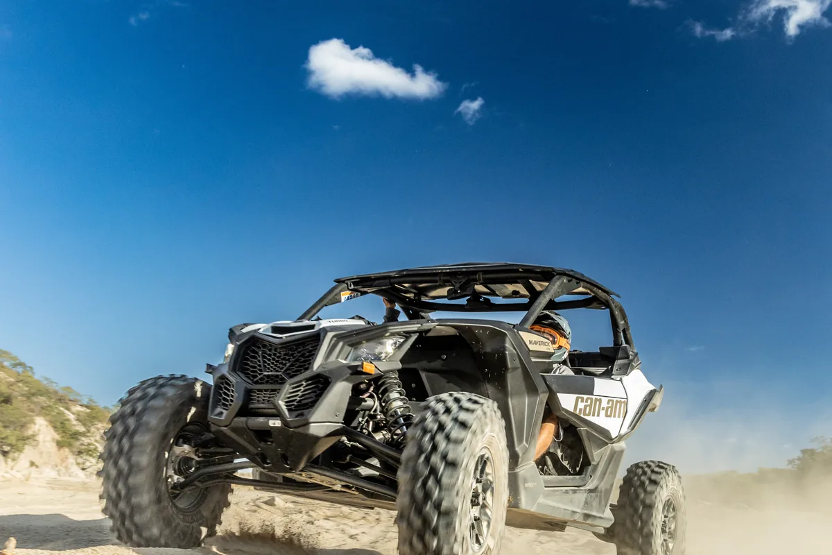A UTV powering through the sand on the East Cape run