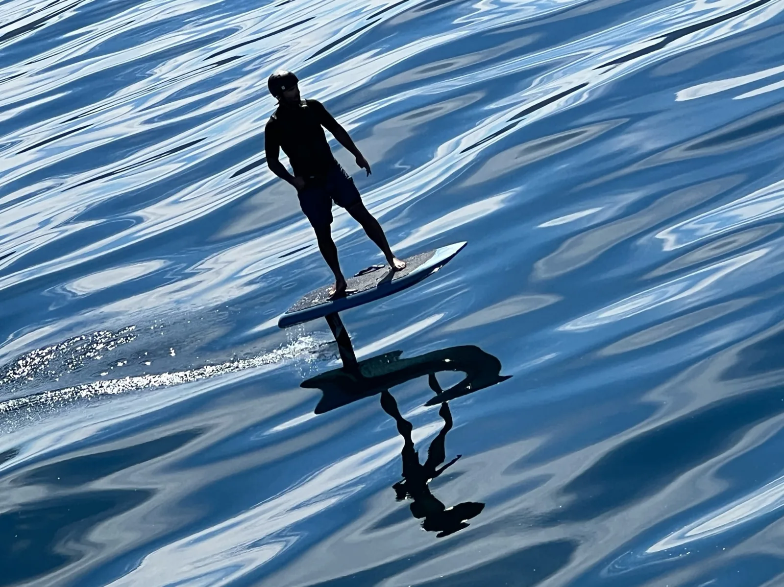 An e-foil board flying above the water