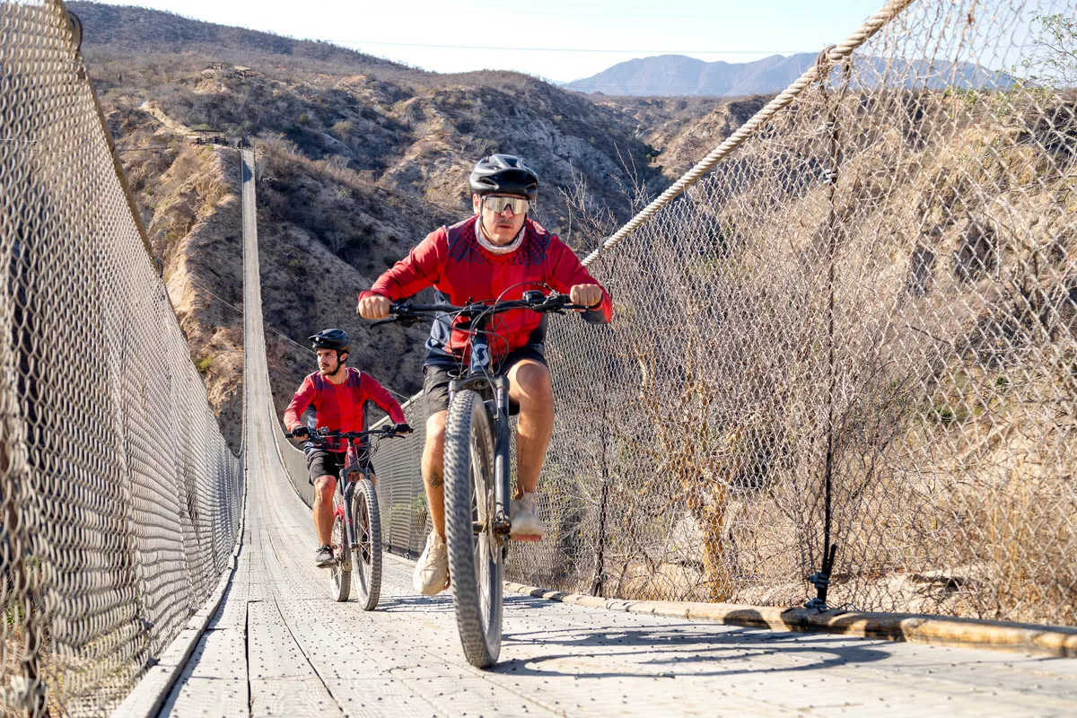 Riding e-bikes across the canyon hanging bridge