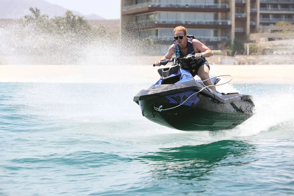 A jet ski at full speed along the shore