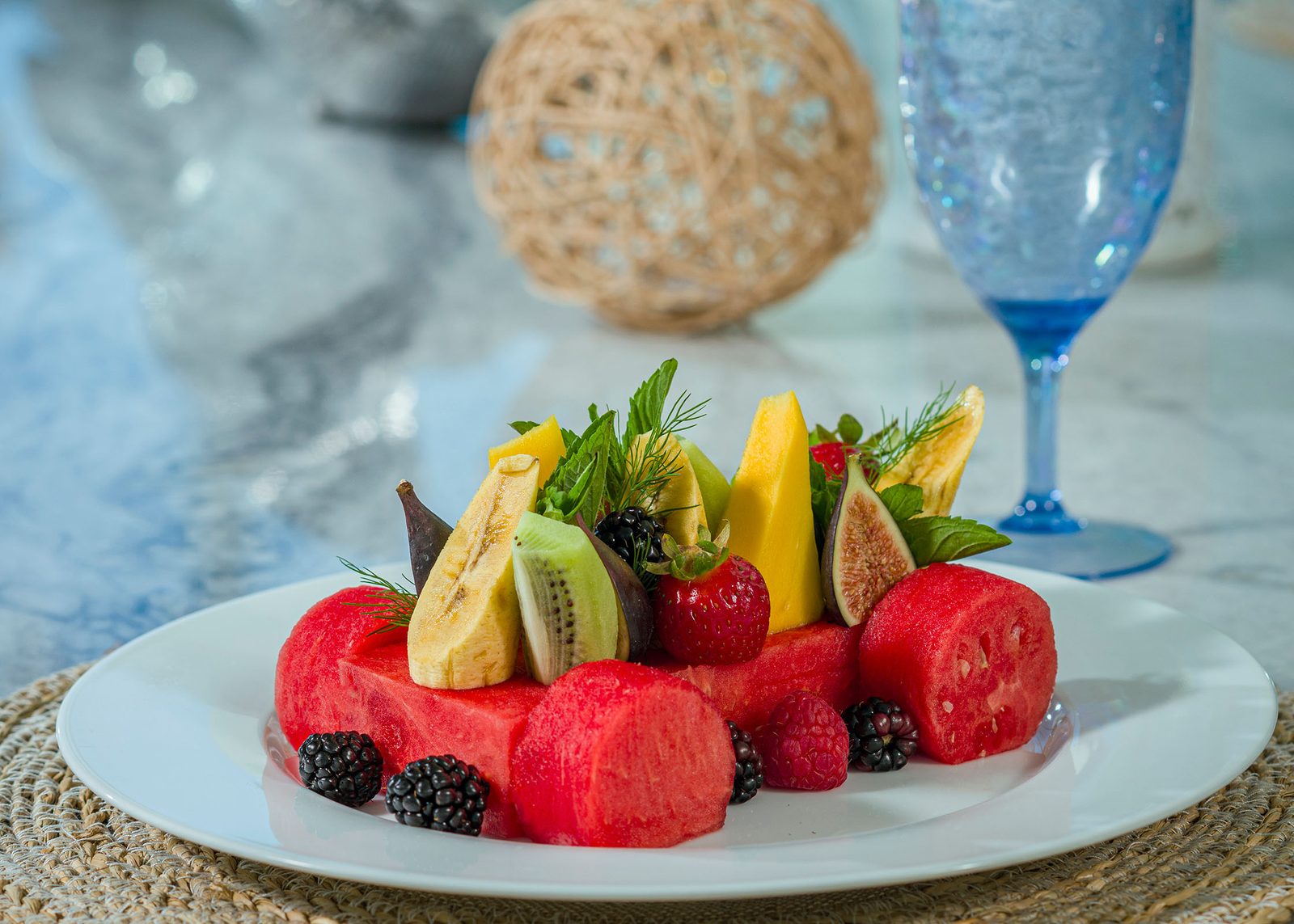 Fresh tropical fruit fan with mango, kiwi, fig and berries