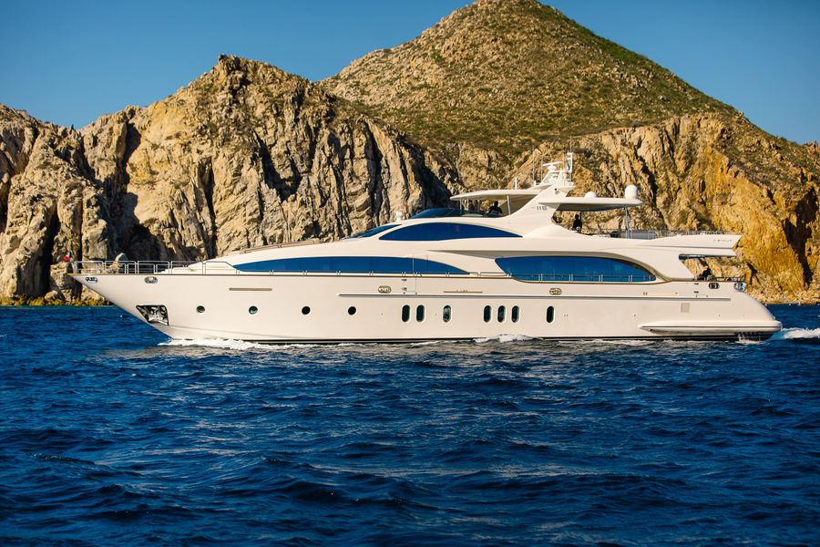 Private luxury yacht charter cruising past the Land's End rock formations in Cabo San Lucas